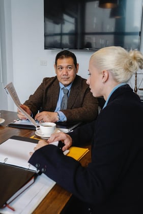 business man and woman having a conversation about marketing-based decisions