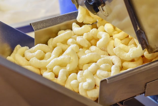 corn puffs in production on a electrical industral vibrator